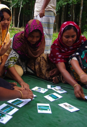 A group of women engage in a card sort activity.